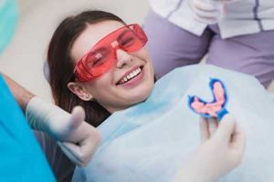 fluoride treatments tx, girl smiling in dentist chair