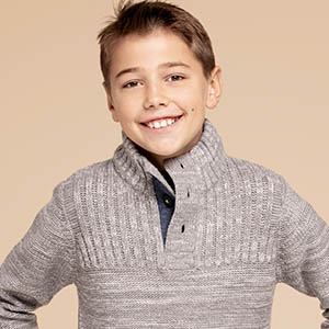 boy with grey sweater smiling