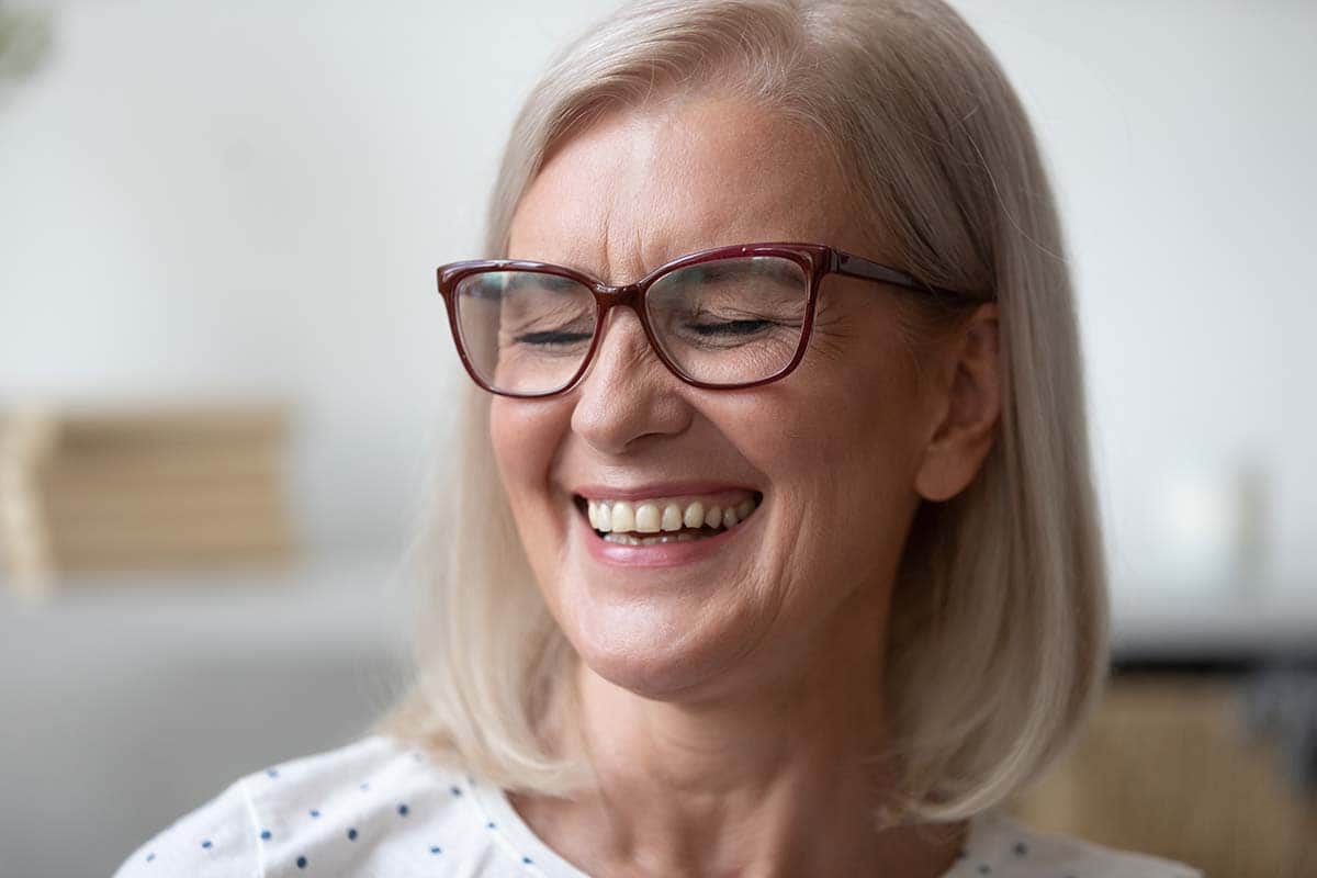 what sugar does to teeth woman laughing after she learns what sugar does to teeth and how to protect her own