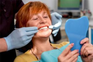 woman getting fitted for dentures