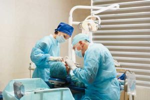 dentists performing oral surgery on a patient