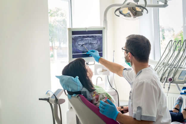 Experience the Many Benefits of Dentists Open on Saturdays woman seeing her Saturday dentist