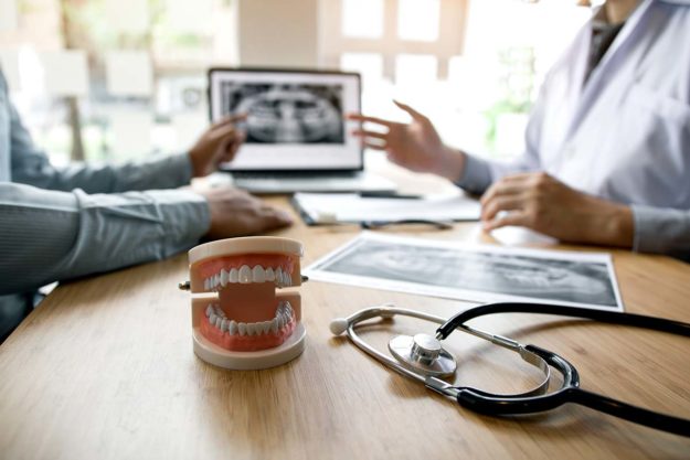 How to Know What Is a Dental Emergency dentist explaining xrays for dental emergency