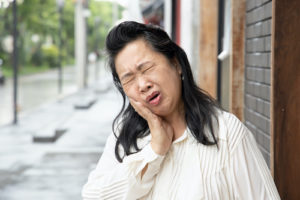 woman suffering from impacted teeth