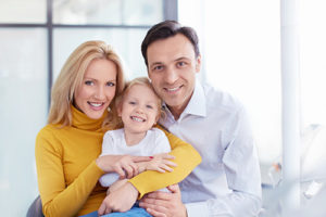 parents with child learning about family dentistry