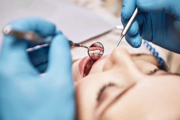 4 Benefits of Dental Implants (1) woman learning about her death implant